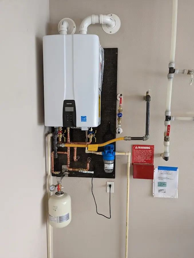 Professional plumber installing copper piping in a Flint home